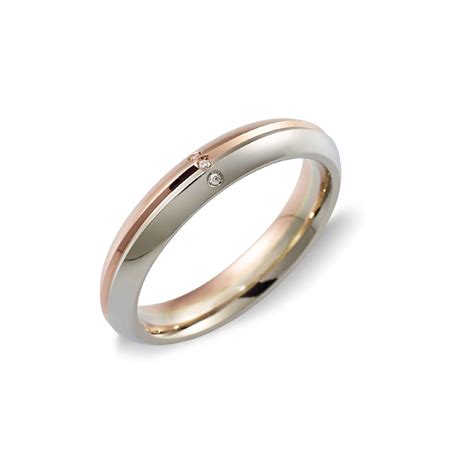 Vetrina di fedi nuziali UNOAERRE in oro bianco e rosa
